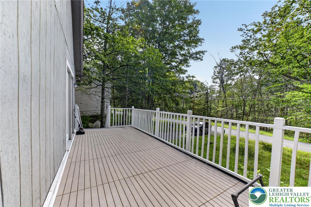 Image 3: Enjoy outdoor living on this expansive deck, surro