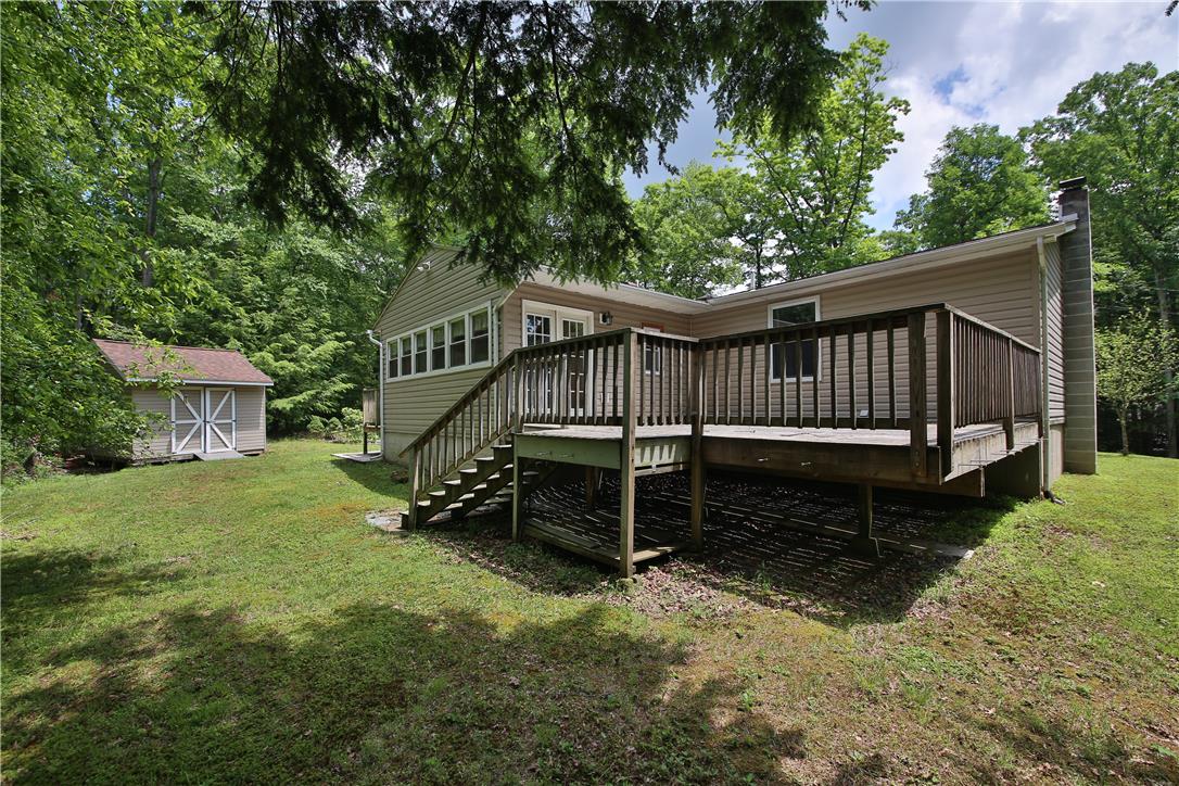 Image 2: A spacious wooden deck provides an outdoor extensi