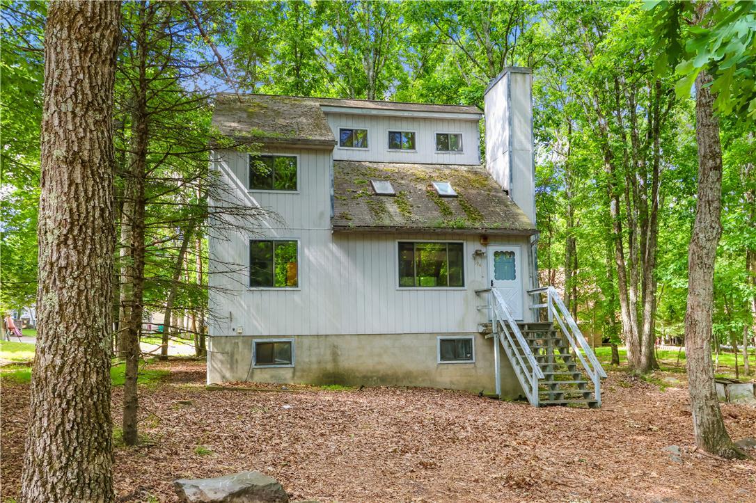 Image 4: A secluded multi-level home nestled among mature t