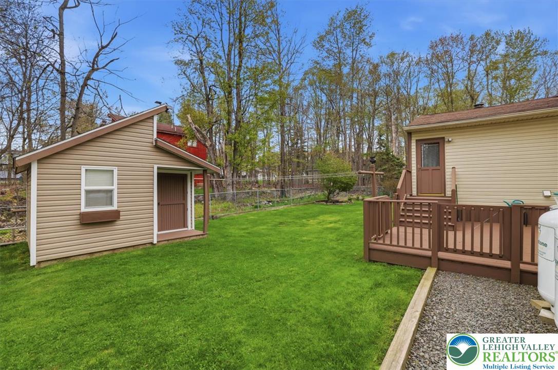Image 2: This verdant yard boasts a functional shed and a d