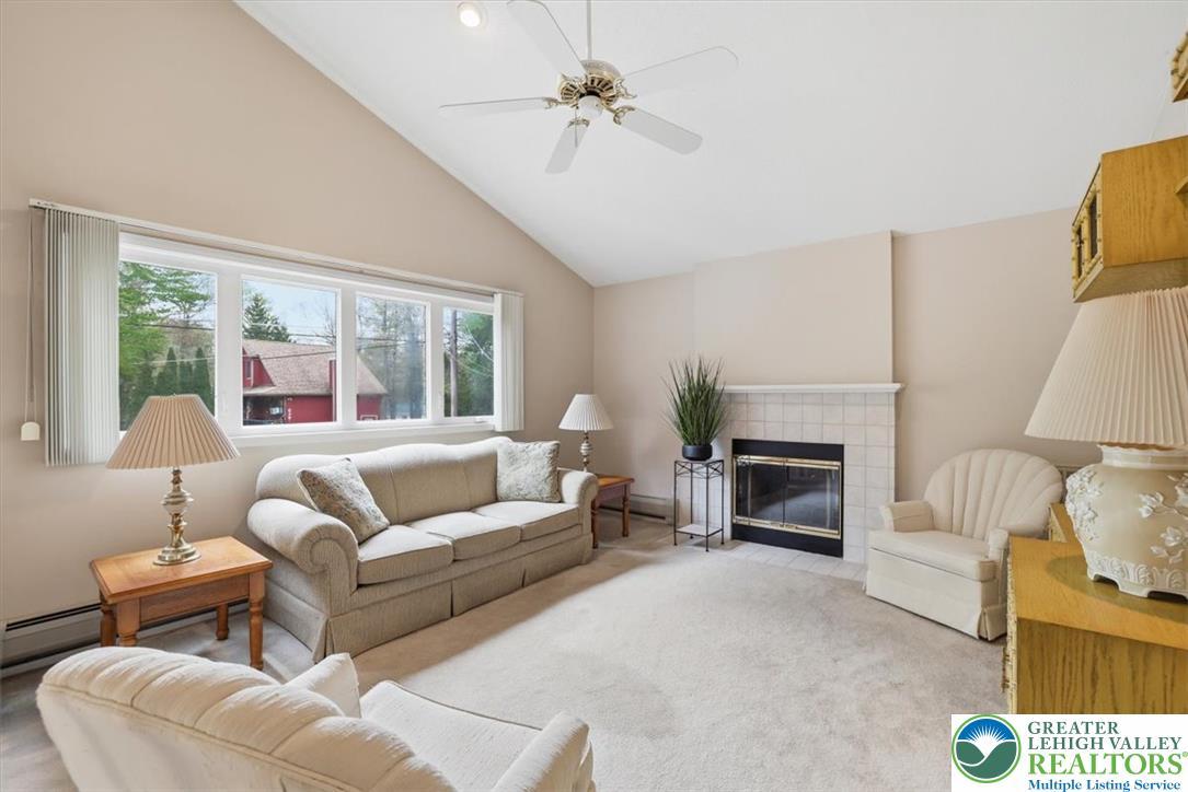 Image 4: This inviting living area features a warm fireplac
