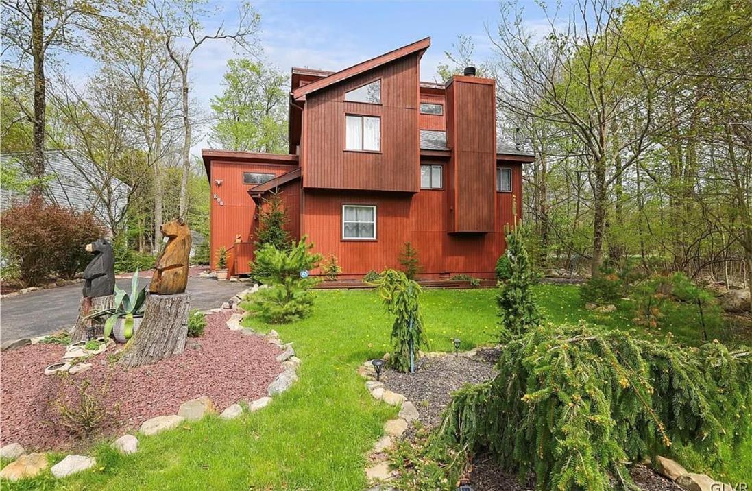 Image 2: Bold modern architecture framed by mature trees, t