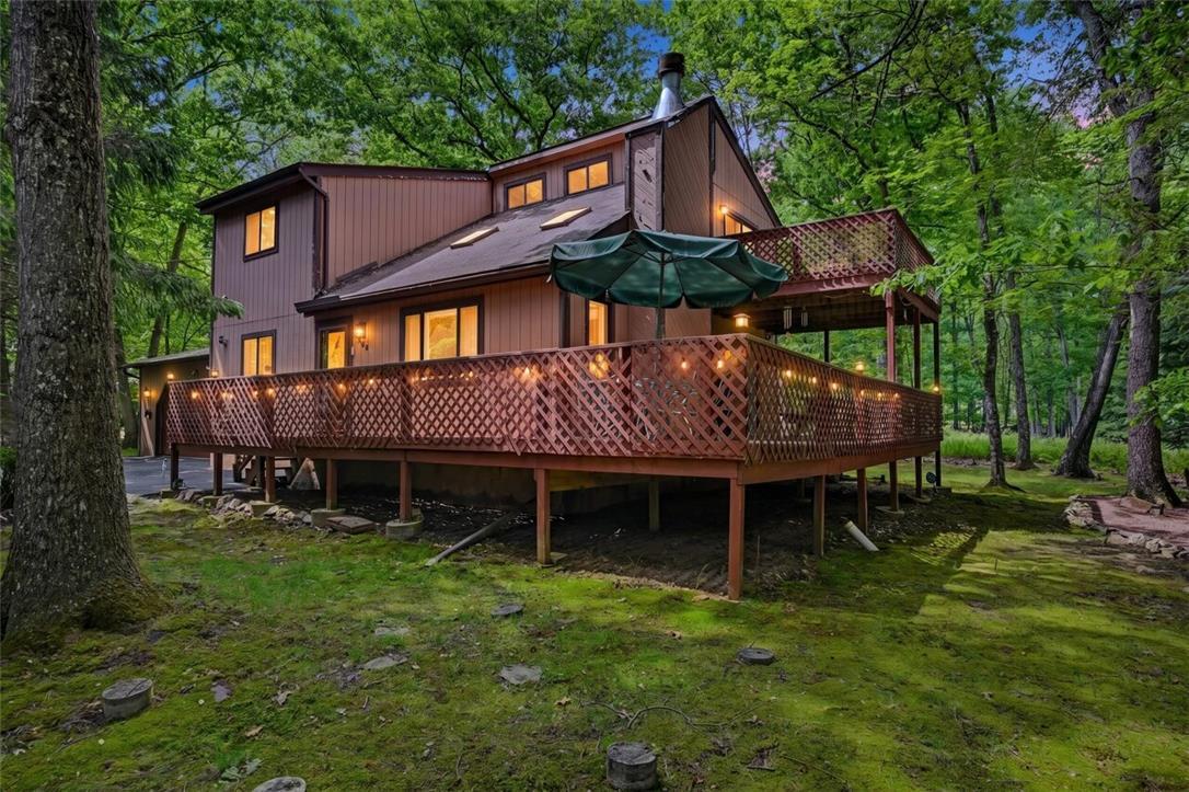 Image 2: A spacious raised deck offers outdoor living amids