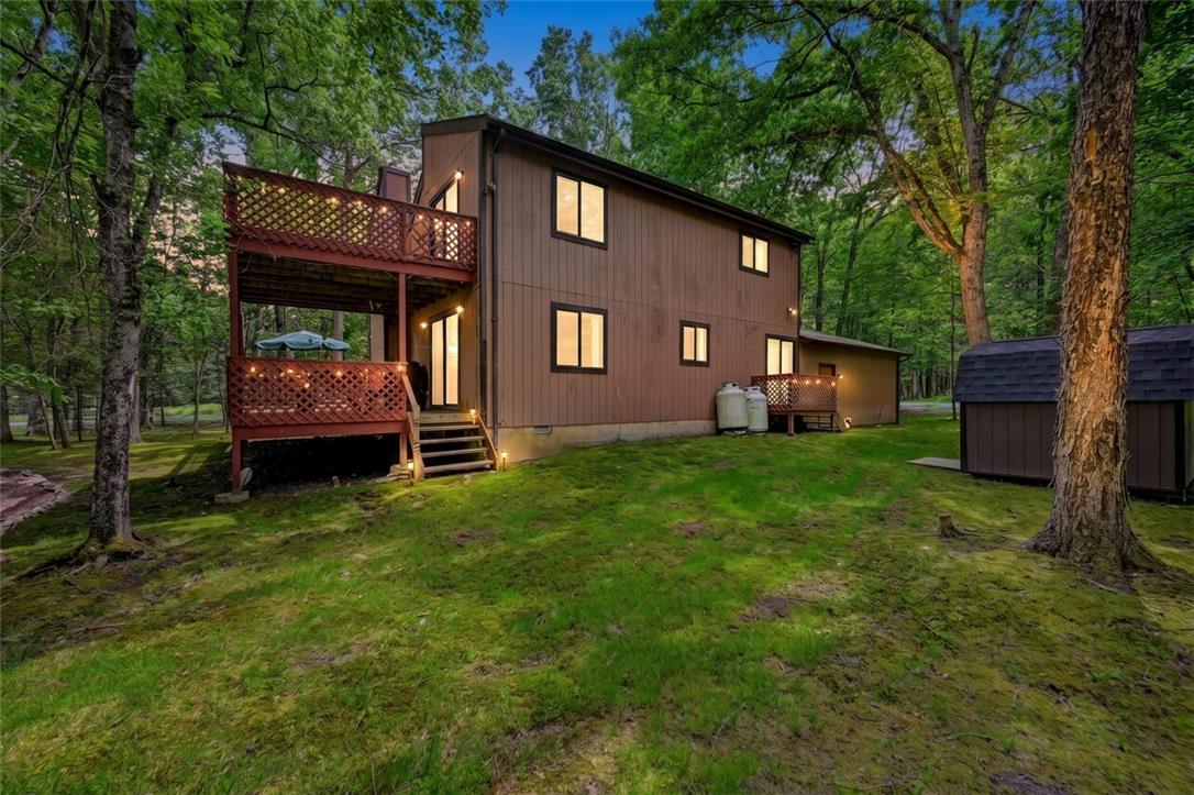 Image 4: A tranquil woodland setting surrounds this cozy ho