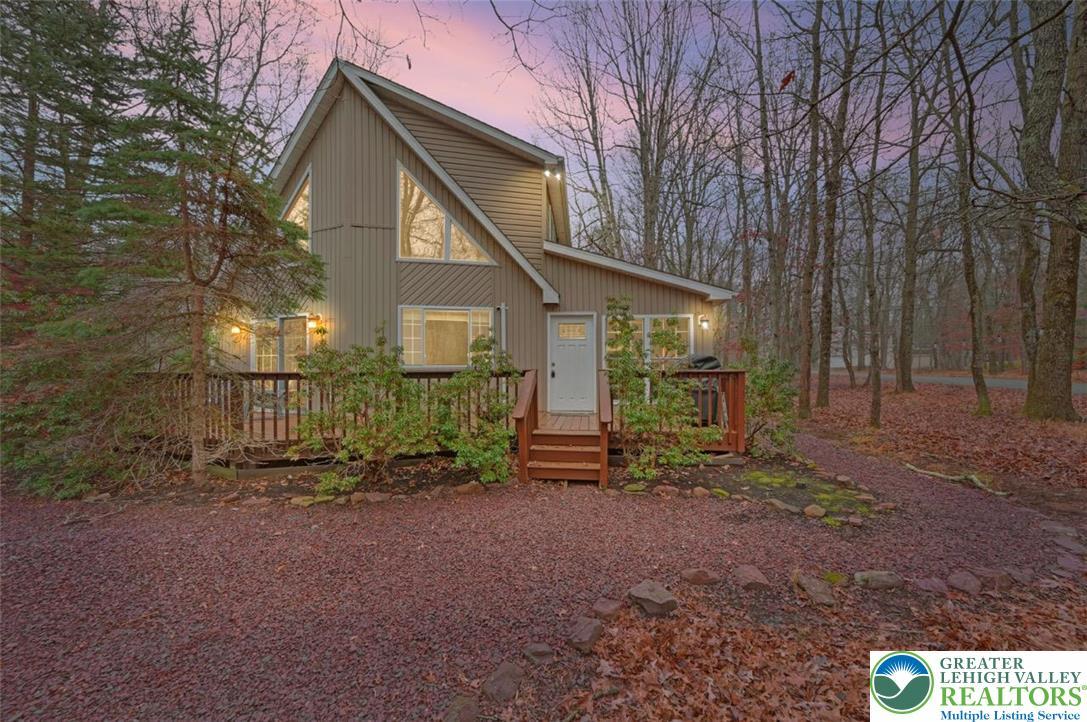 Image 2: The home features low-maintenance vinyl siding and