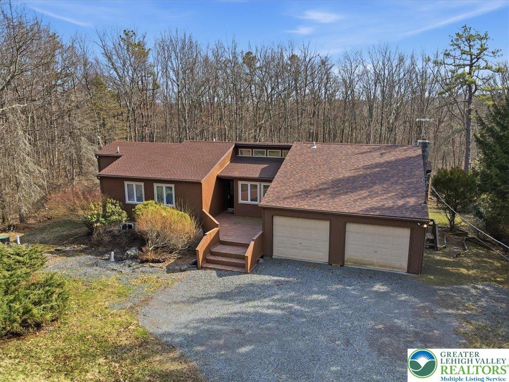 Image 2: A spacious home with a two-car garage sits on a wo