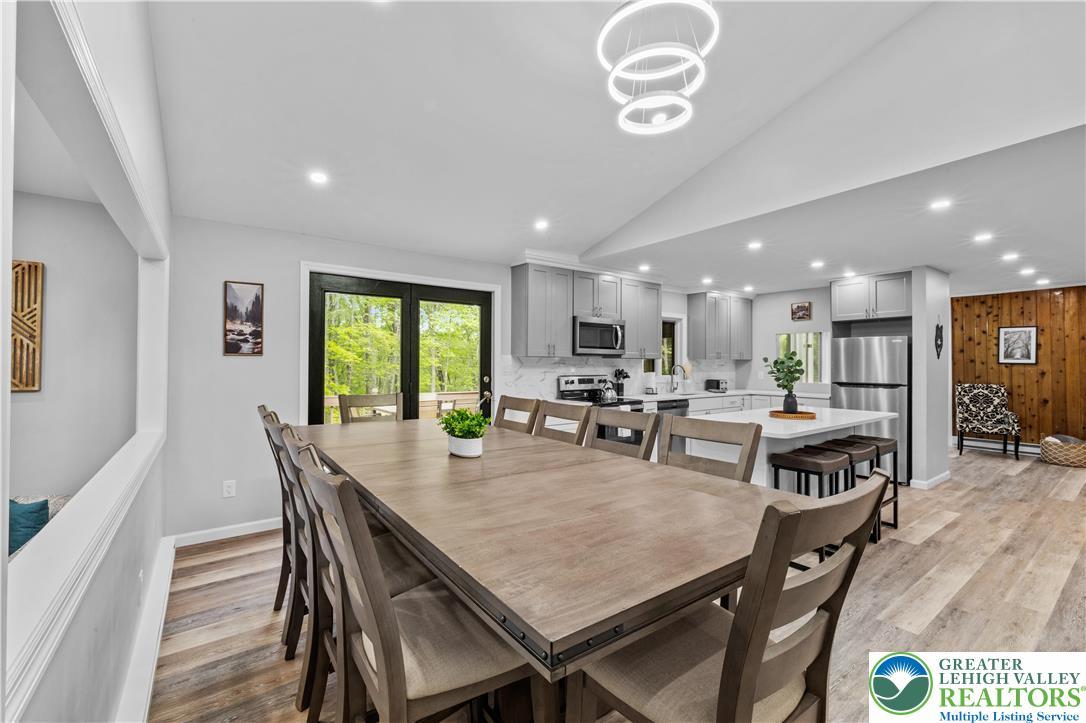 Image 4: Discover a spacious dining area with wood flooring