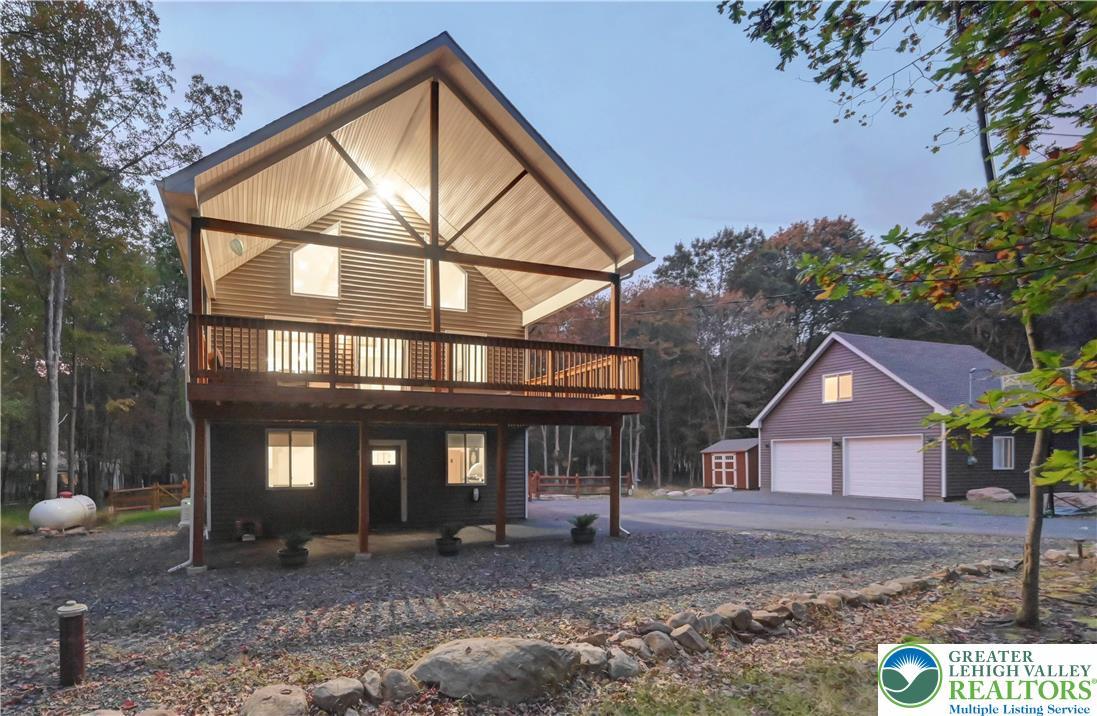 Image 2: Dusk view of the home featuring a 415+sf covered c