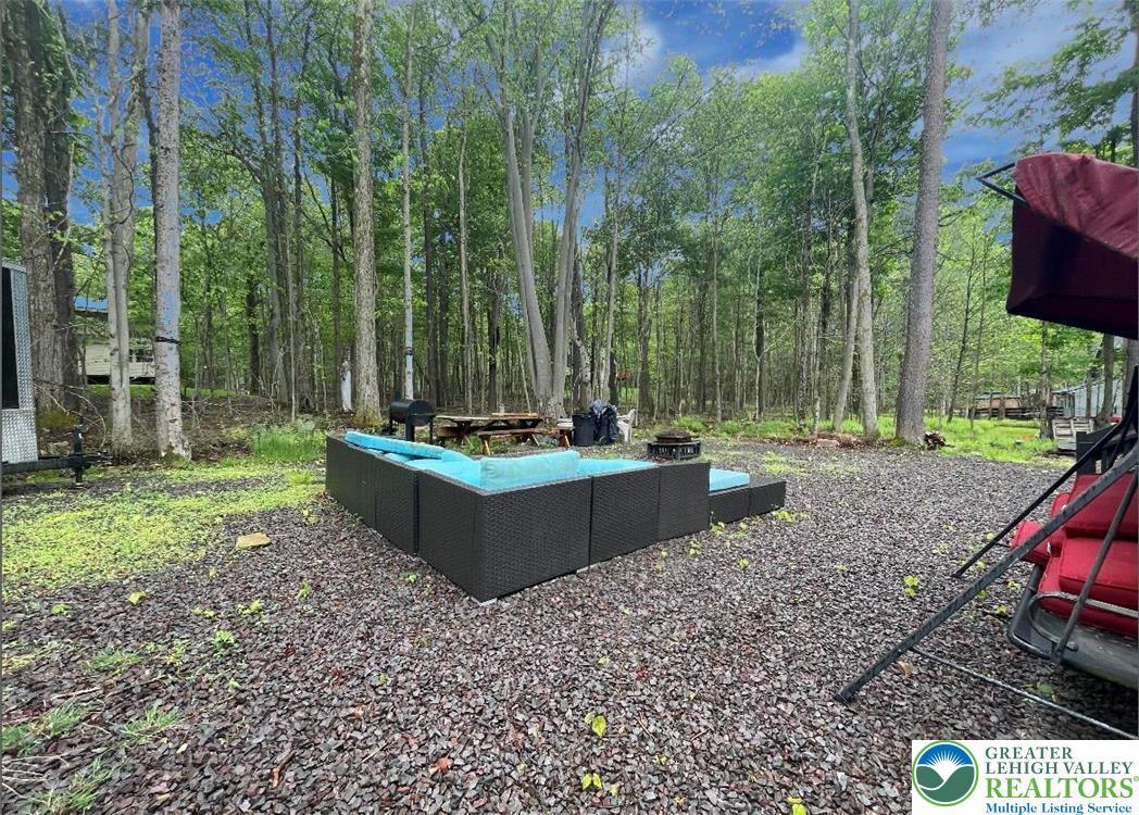 Image 4: An inviting outdoor seating area nestled among ver