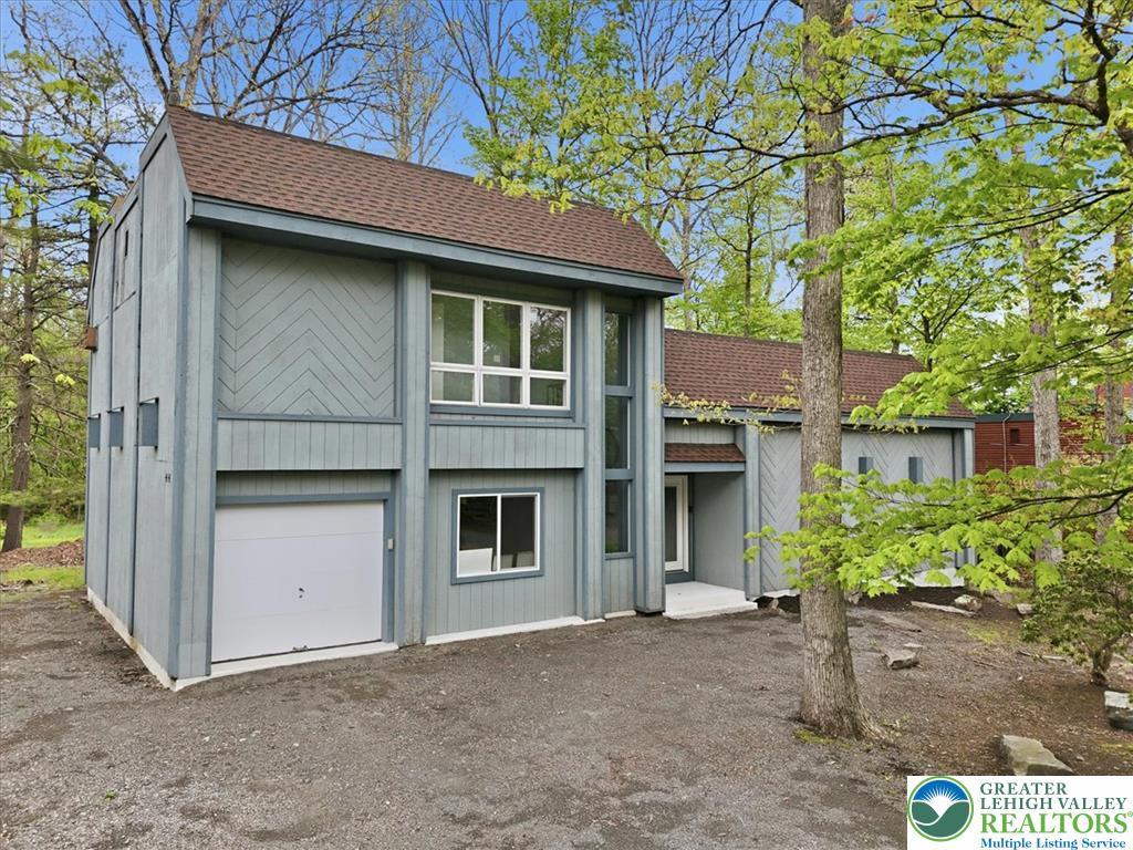 Image 1: This secluded property, surrounded by vibrant gree