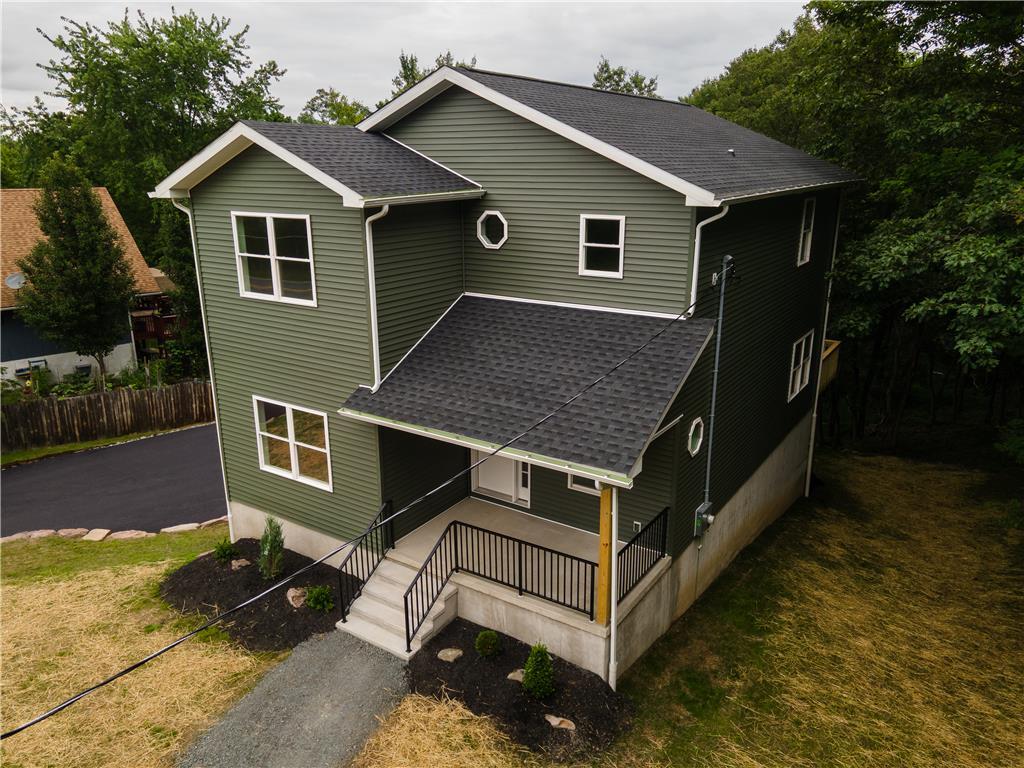 Image 1: A newly constructed residence features a distincti