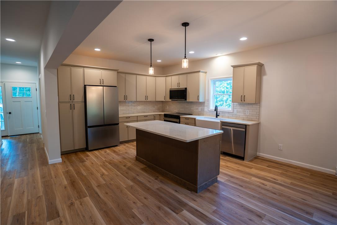 Image 4: A well-appointed kitchen features stainless steel
