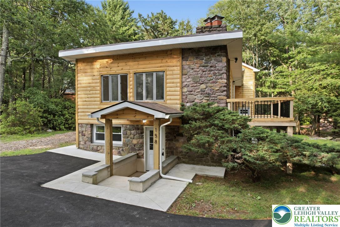 Image 2: A charming blend of log and stone construction cre