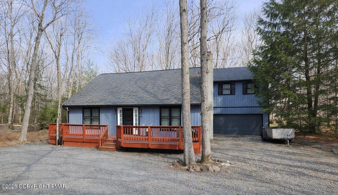 Image 1: This inviting residence features a spacious deck,