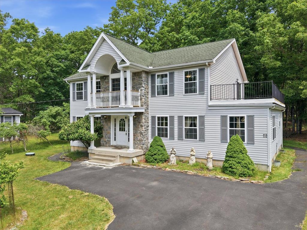 Image 4: A charming home nestled amongst green trees offers