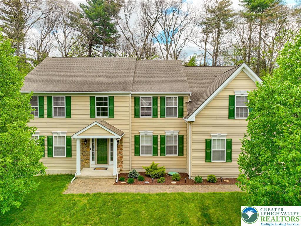 Image 1: This classic two-story residence features a welcom