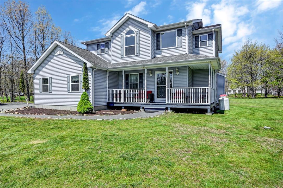 Image 3: The home features low-maintenance vinyl siding and