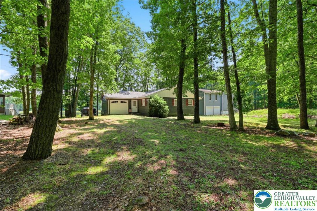 Image 2: A secluded ranch home nestled amongst mature trees