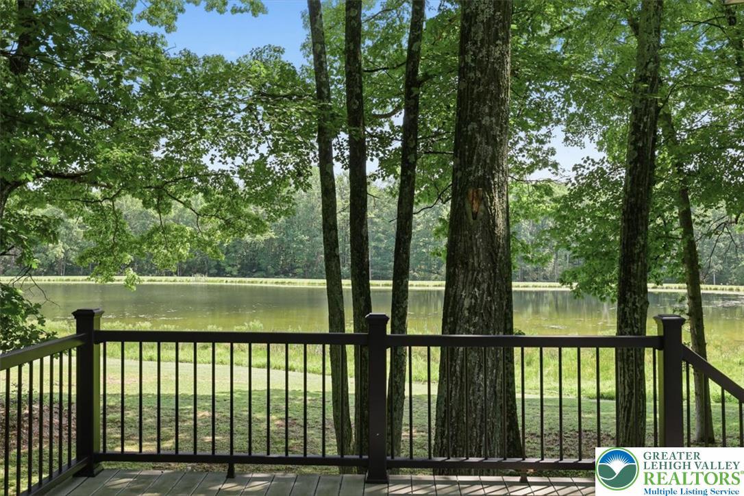 Image 4: A tranquil lake view from a spacious deck, envelop