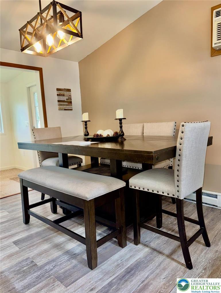 Image 4: This naturally illuminated dining space offers an