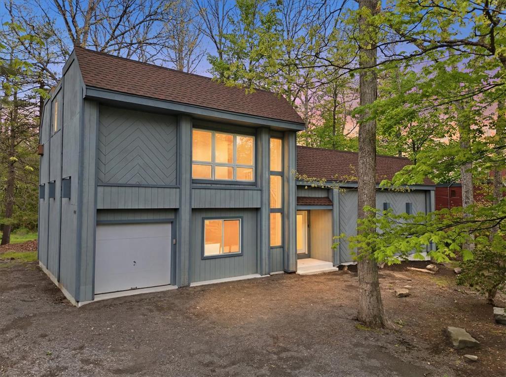 Image 2: This secluded forest dwelling features an attached
