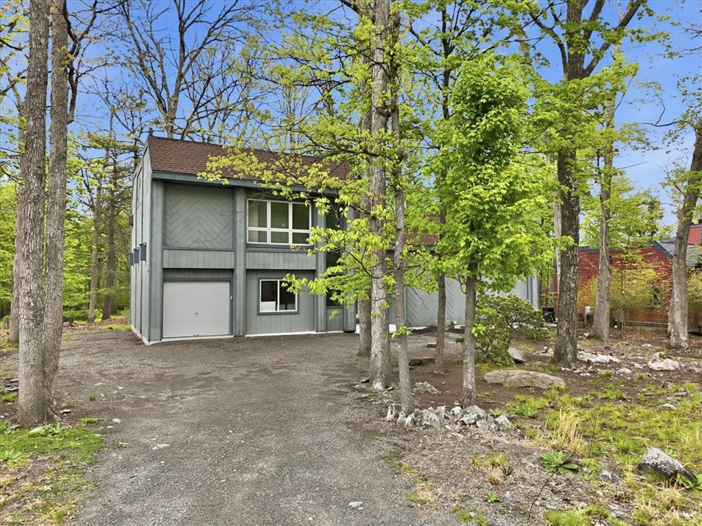 Image 3: A private wooded setting surrounds this charming m