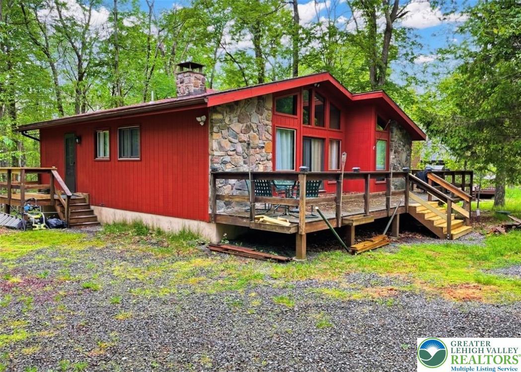 Image 4: A charming rustic retreat with a spacious deck, pe