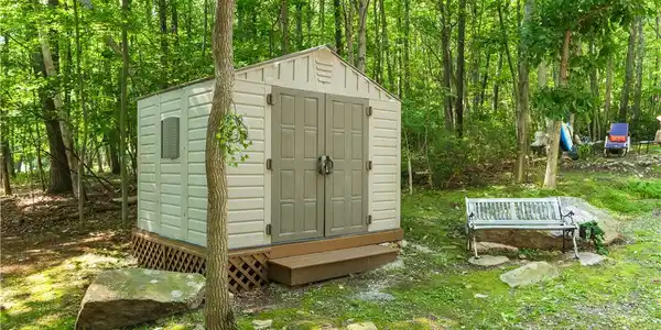 Image 4: A practical storage shed stands nestled within a t