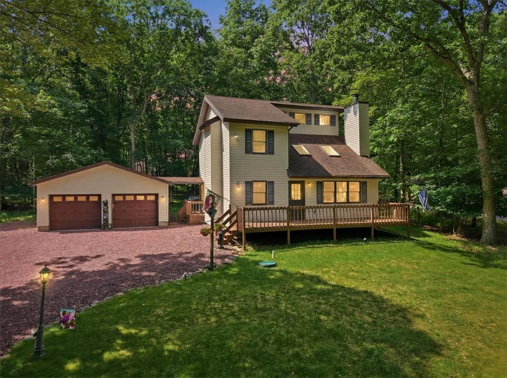 Image 2: A classic two-story residence boasts a detached ga
