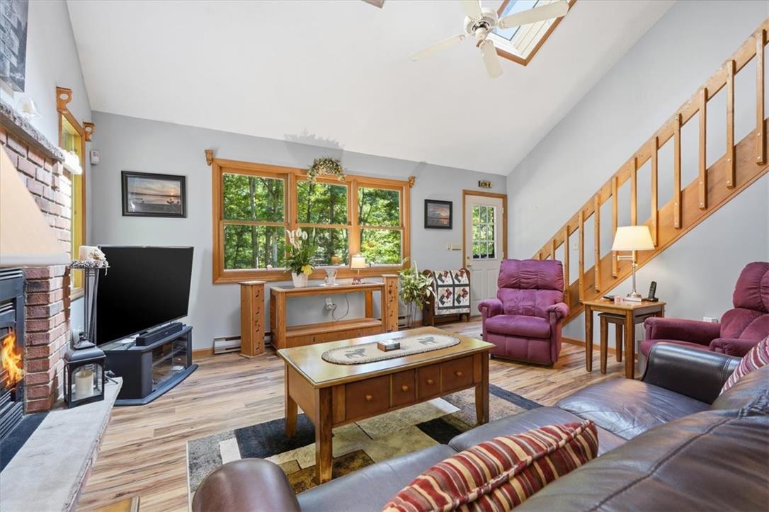 Image 4: A sun-drenched living area boasts high ceilings, a