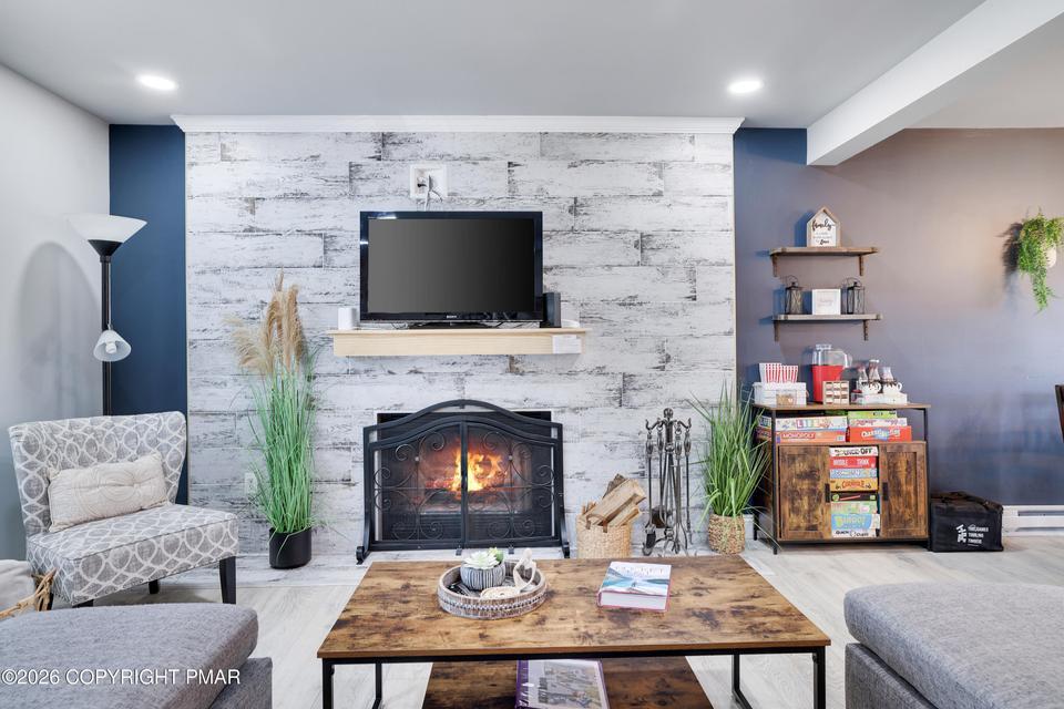 Image 2: A comforting glow emanates from the fireplace, gro