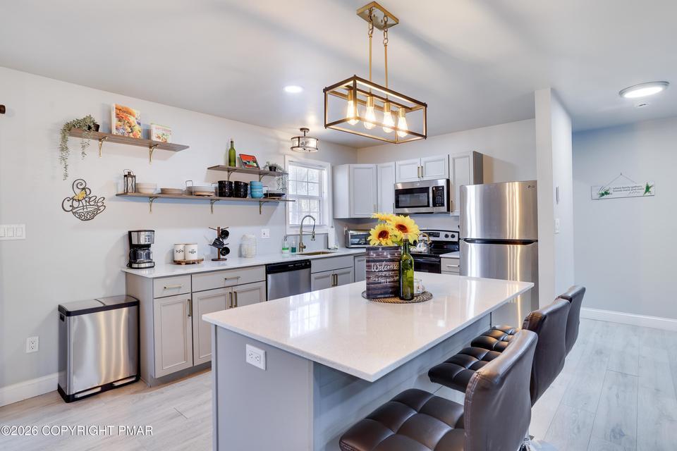 Image 3: Sleek stainless steel appliances complement the ai