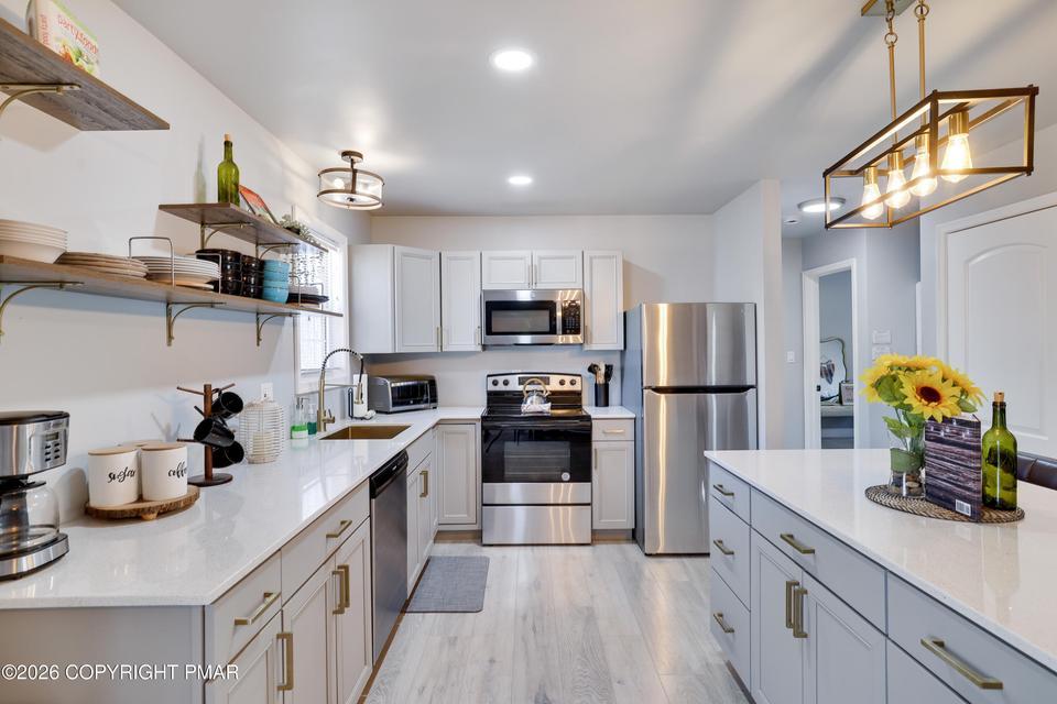 Image 4: A well-appointed kitchen showcasing bright white c