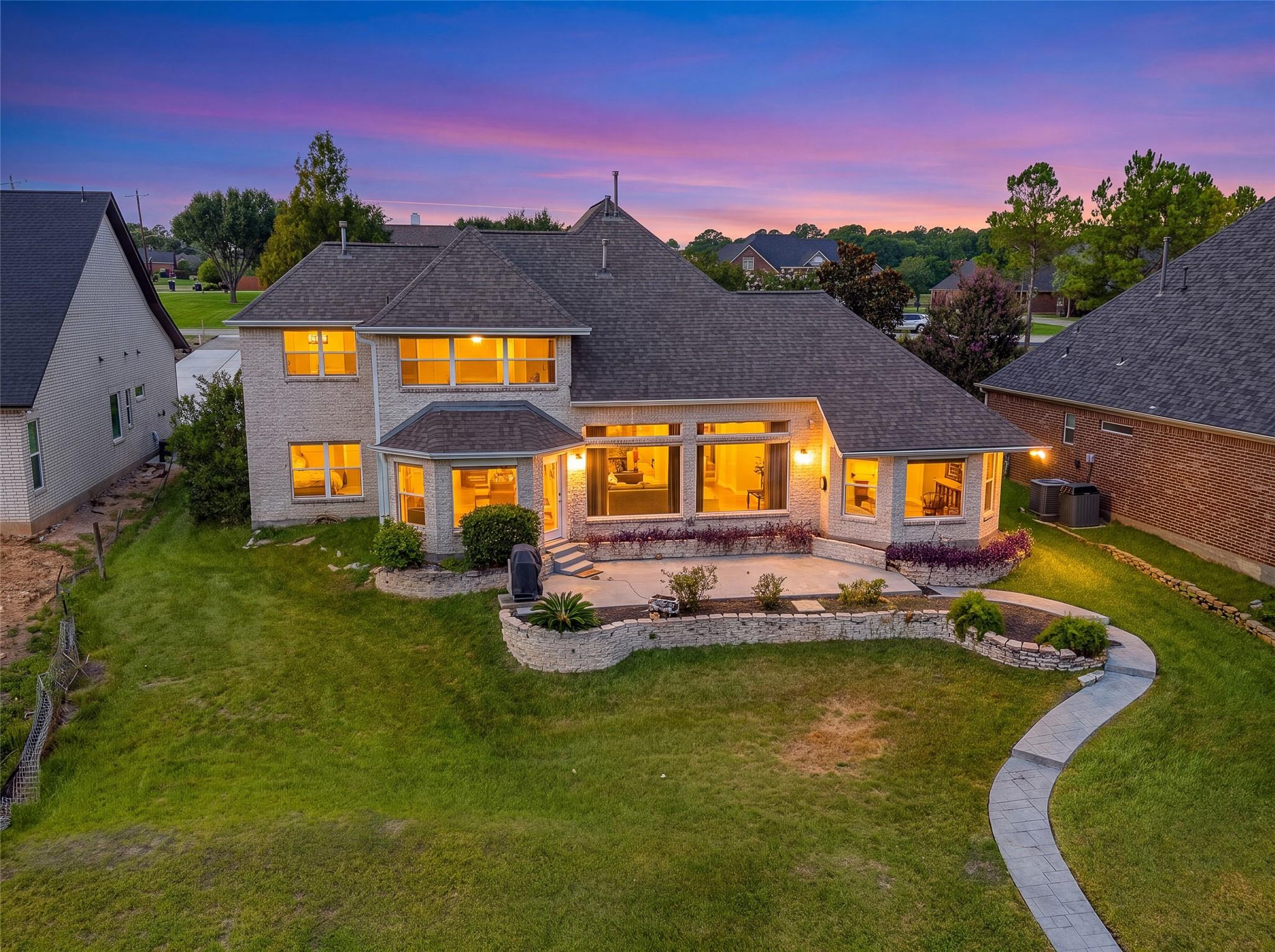 Image 1: This photo showcases a spacious two-story brick ho