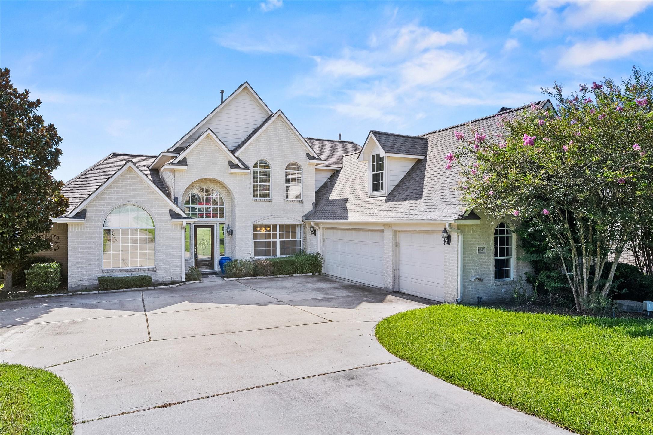 Image 2: This spacious two-story home features a classic br