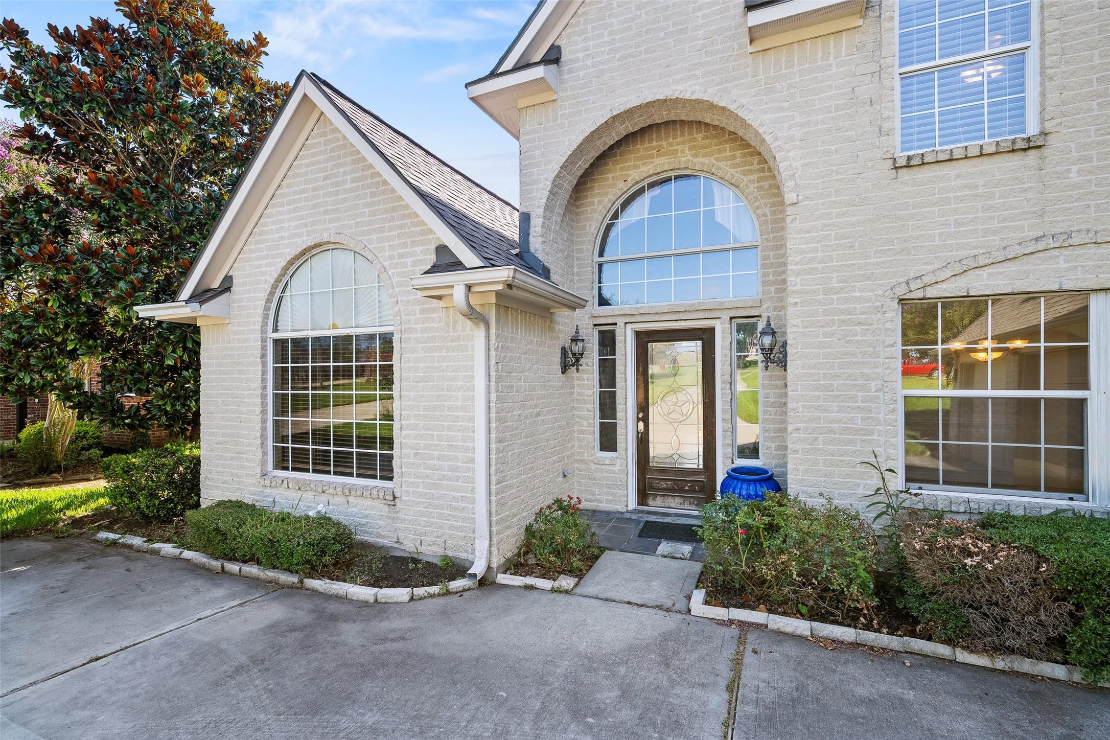 Image 4: This photo showcases a charming brick home exterio
