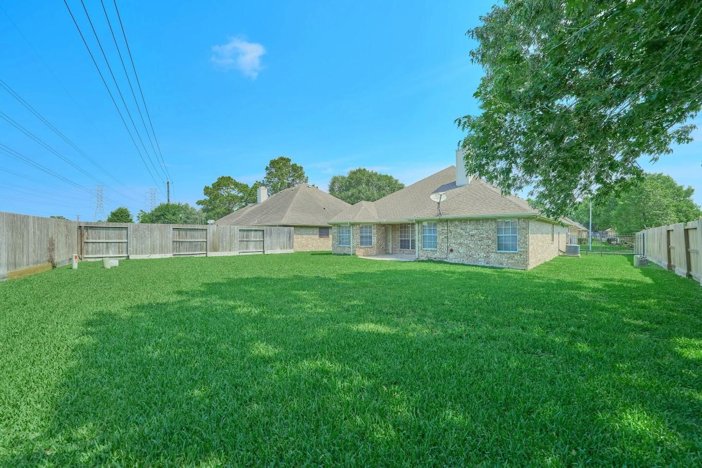 Image 3: Look at this backyard! This home is located on one