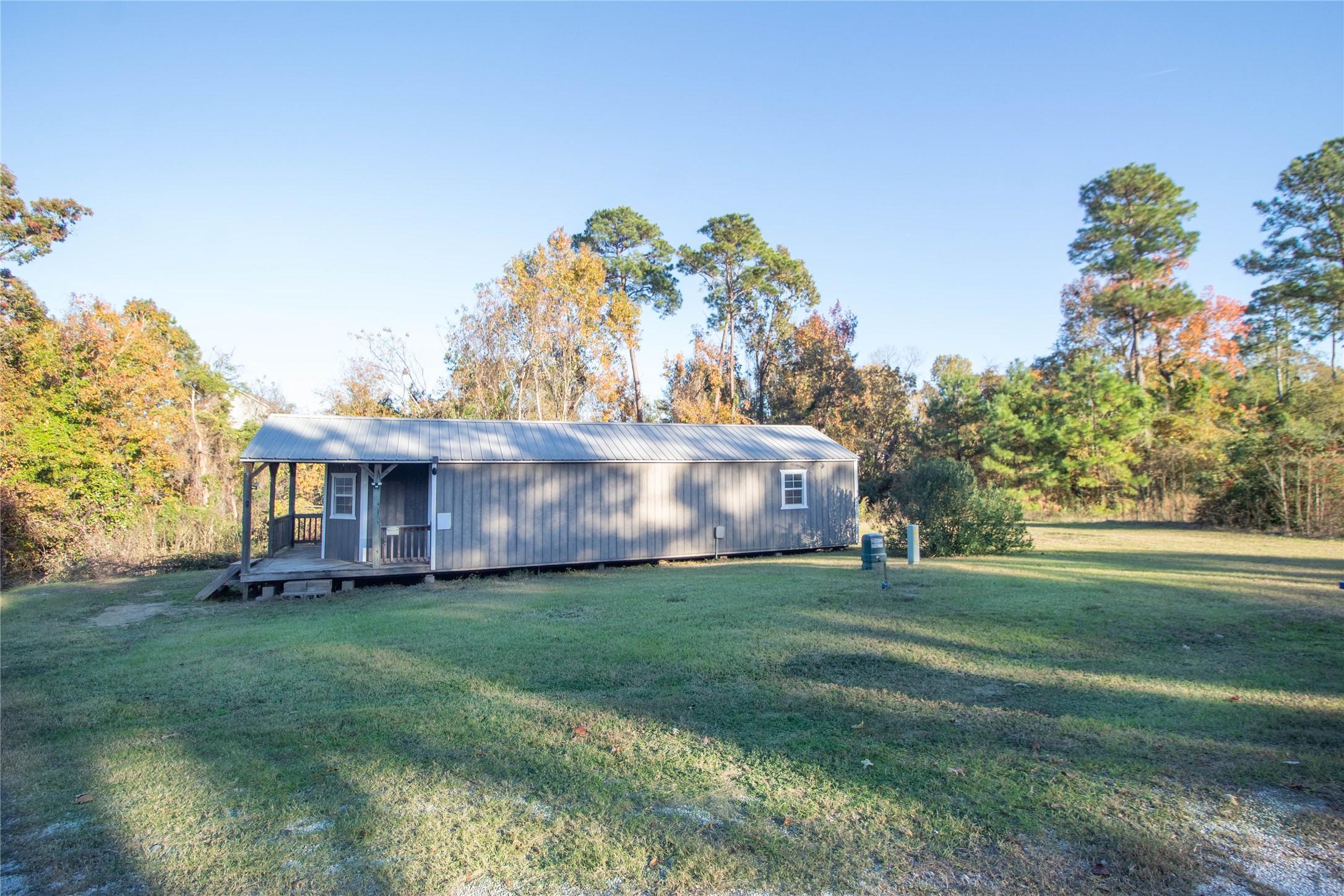 Image 1: This property features a rustic single-story home