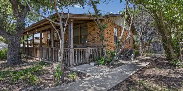 Image 3: Inviting covered front porch with stone walkway, w