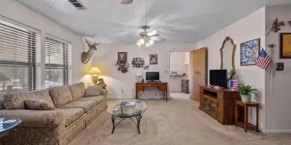 Image 4: Spacious living room featuring carpeted flooring,