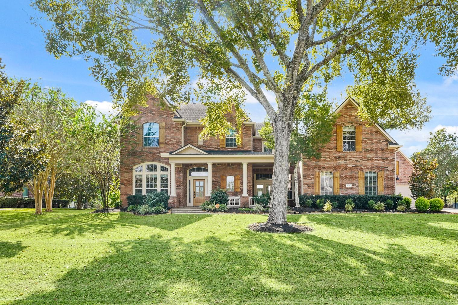 Image 1: Nestled on a lush, half-acre waterfront lot in the