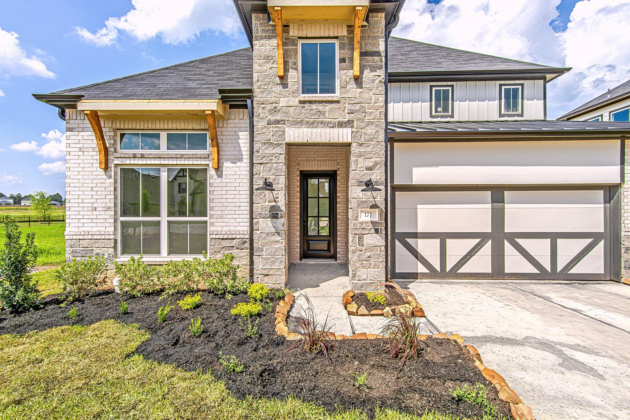 Image 2: A welcoming front entryway framed by stone columns