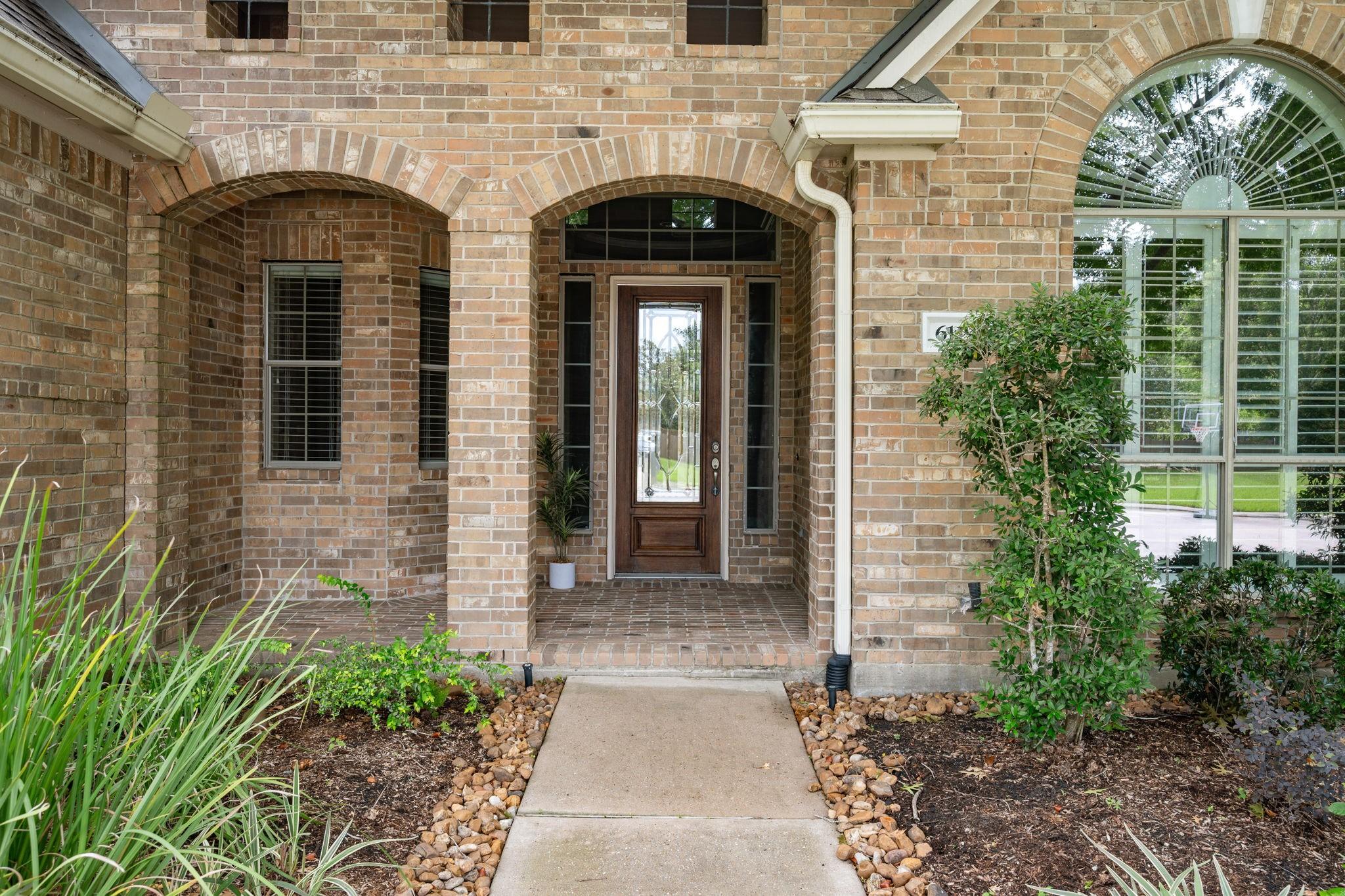 Image 2: Covered front porch at the main entry. offers a we