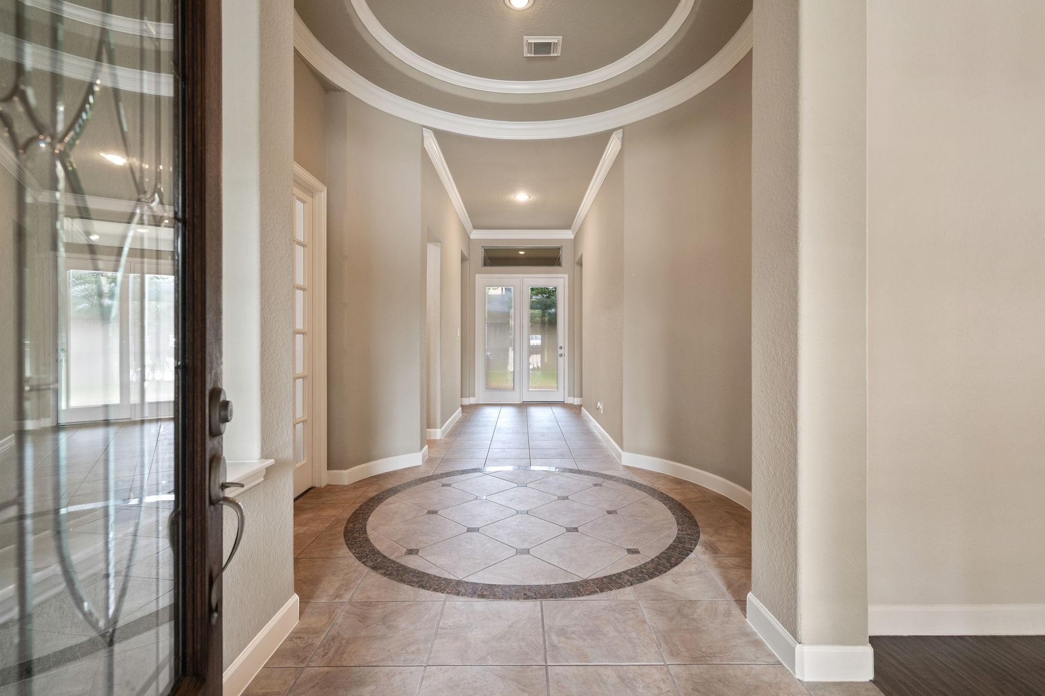 Image 3: Elegant, well-lit entryway has a tiled floor featu