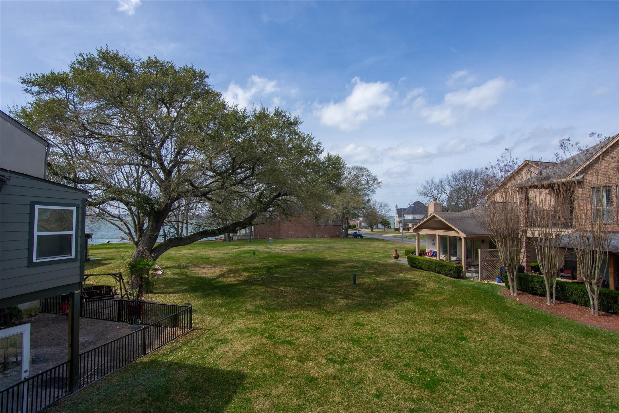 Image 4: Expansive community lawn is lined with mature shad