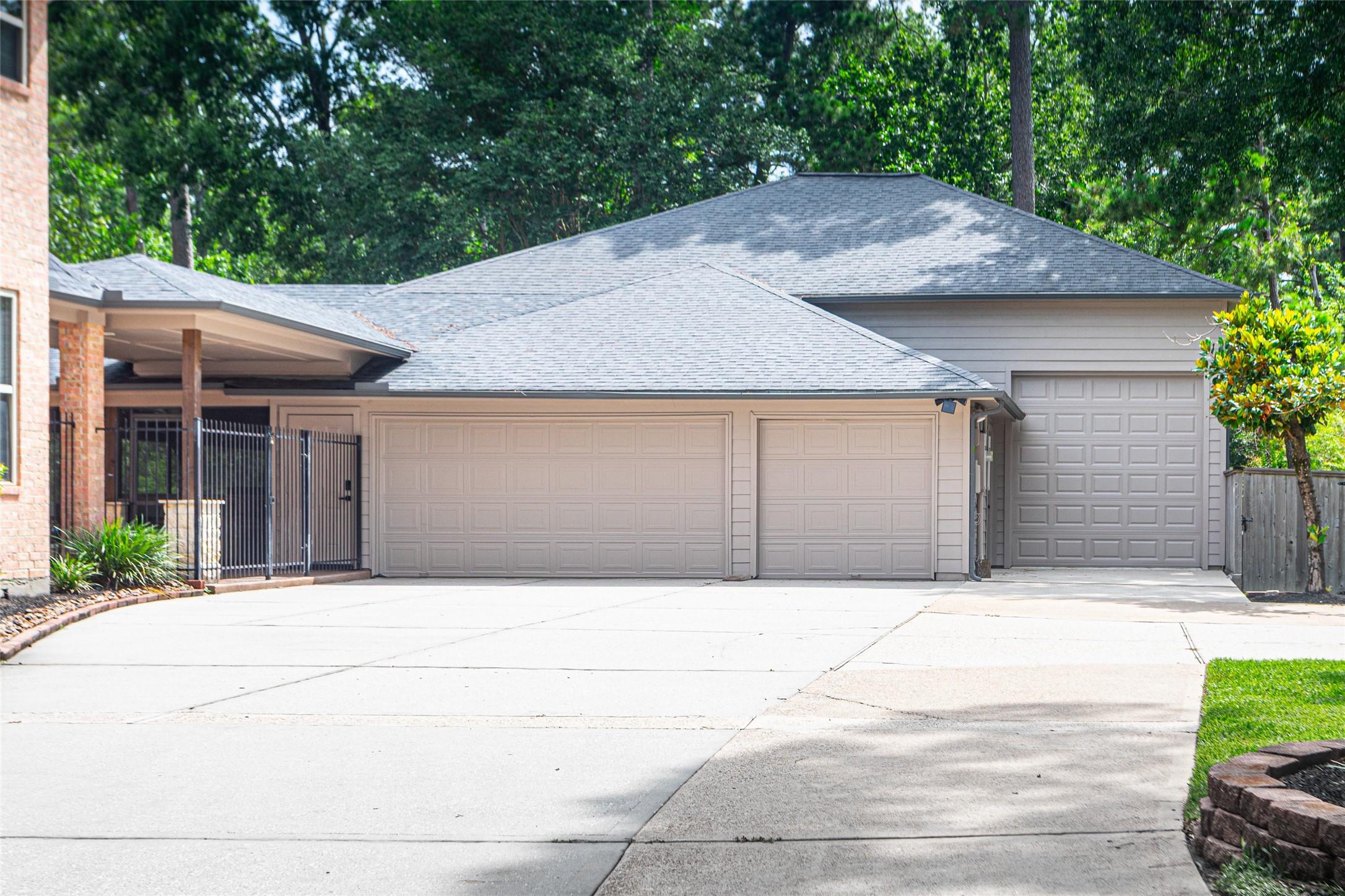 Image 2: Spacious four-car garage with double wide driveway