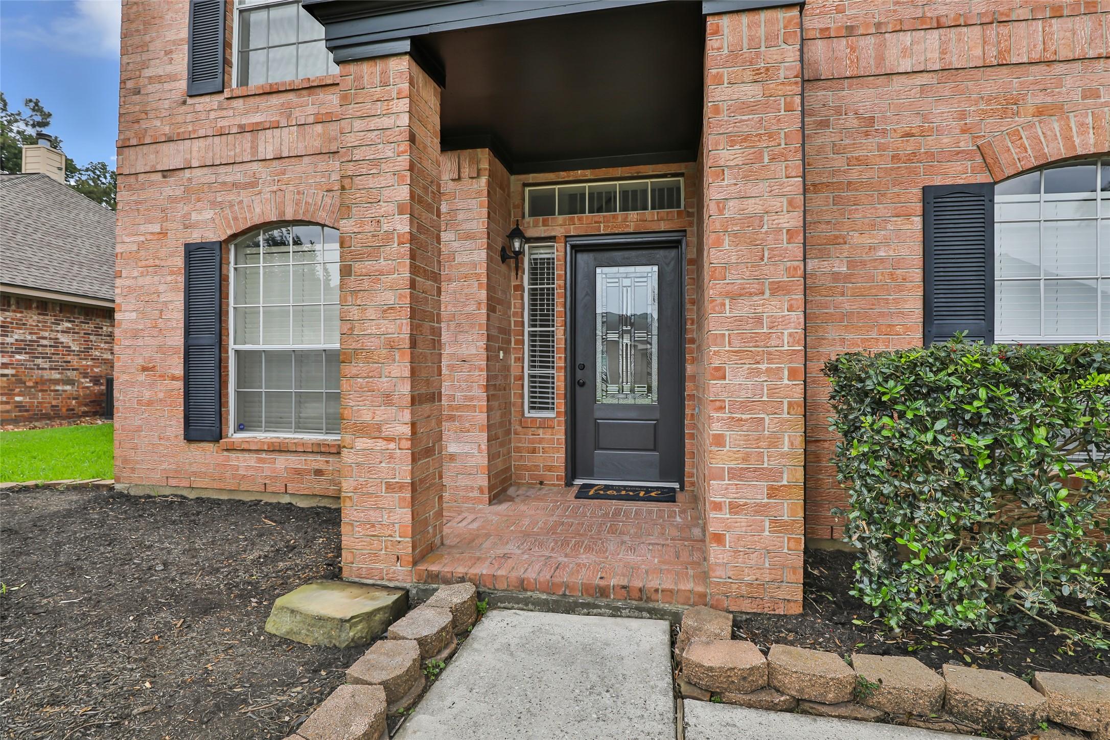 Image 3: A covered entry and dramatic front elevation creat