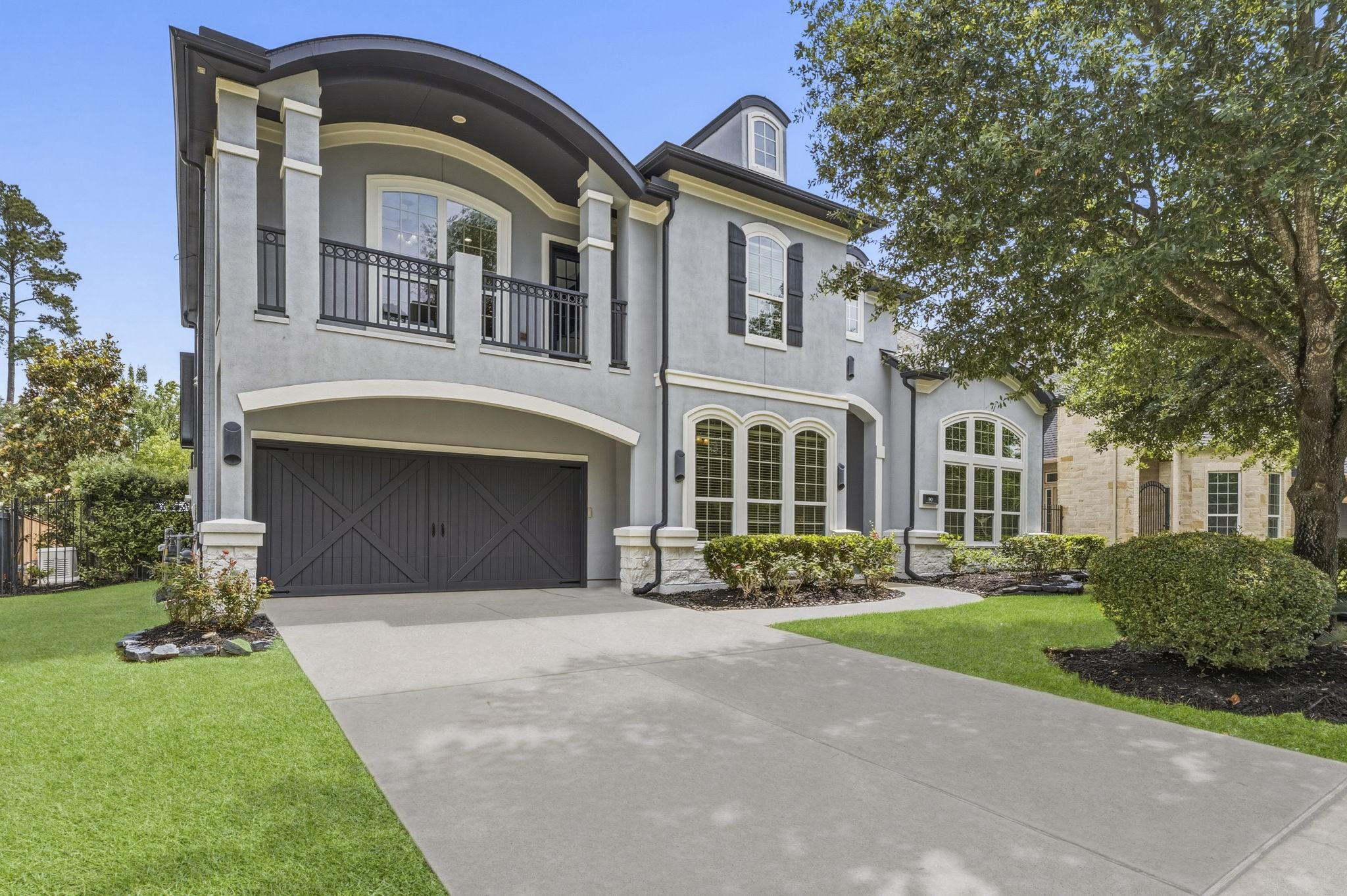 Image 1: Striking modern exterior with clean lines, arched