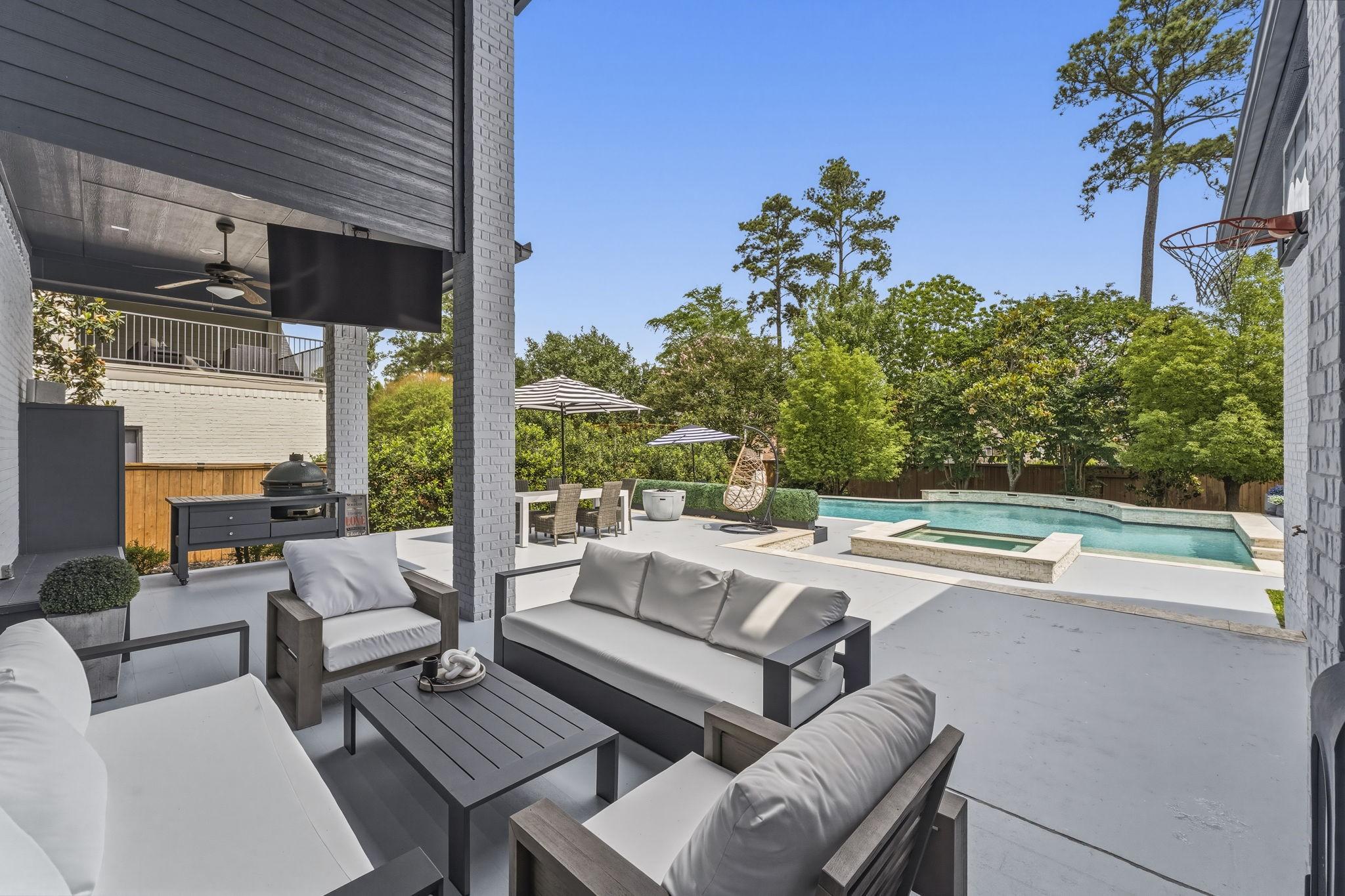 Image 2: Resort-style pool and spa with sleek design, surro