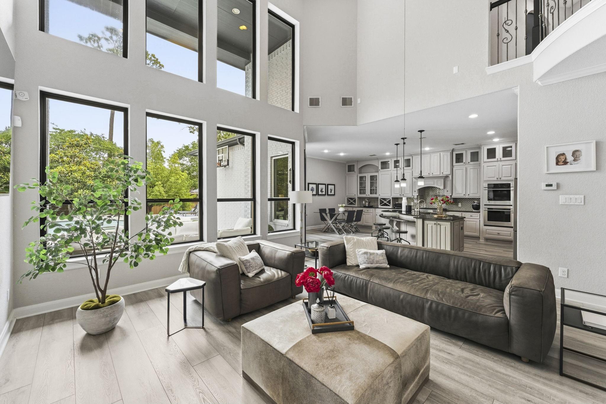 Image 4: Light-filled open-concept living with soaring ceil